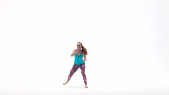 Energetic Girls Are Practicing Capoeira in White Background of Studio. Afro-Brazilian Martial Art