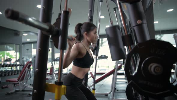Fitness concept, Asian girls are doing squats in the gym