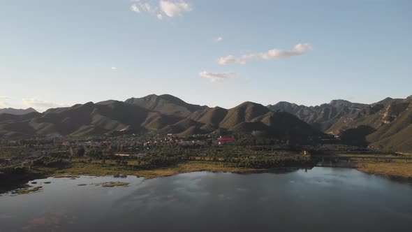 Beautiful mountain range with grassland and lake and village