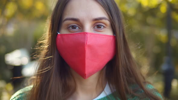 Young Woman in Protective Facial Mask Over Outdoors Background