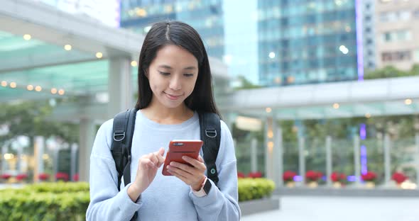 Woman use of mobile phone in city