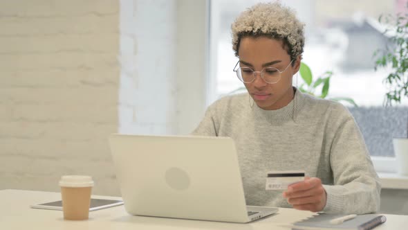 African Woman Making Successful Online Payment on Laptop