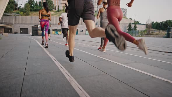 Group of People Jogging Together at Sunrise