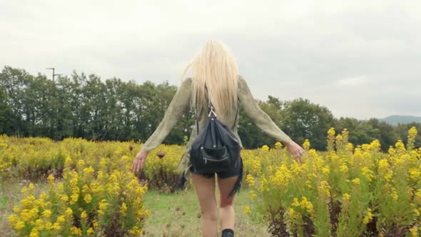 Back View of Beautiful Blond Young Girl Walks Outdoor in Nature Gimbal Steadicam