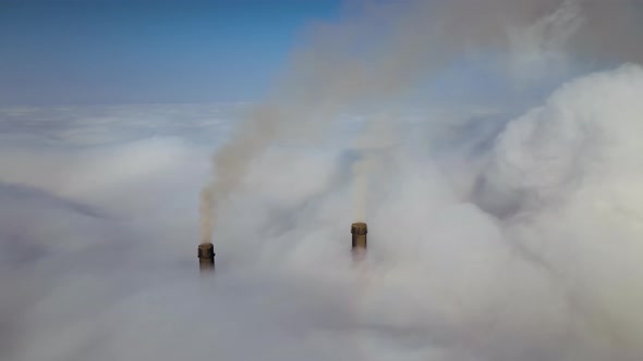 Coal Power Plant High Pipes Emitting Black Poisonous Smoke Moving Upwards Over White Fog Polluting