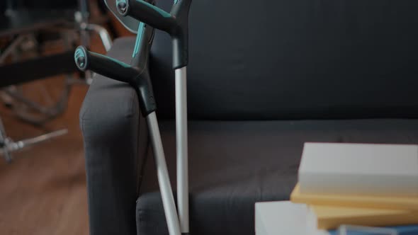 Crutches on Empty Couch in Living Room to Give Mobility Support