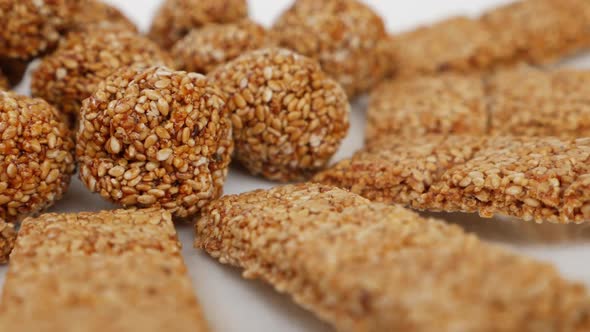 Sesame ladoo and sticks isolated on plate