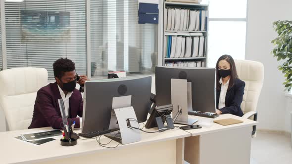 Managers in Face Masks Working in Office