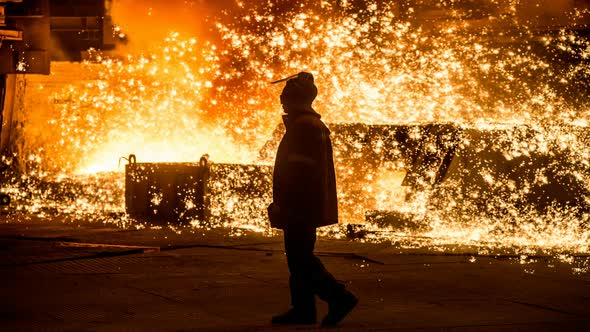 Steelworker near a blast furnace with sparks. Cinemagraph.