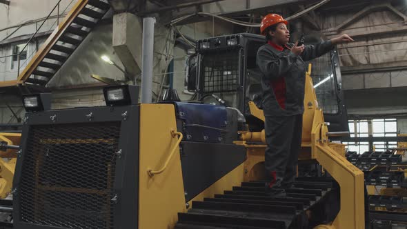 Woman with Walkie Talkie on Bulldozer