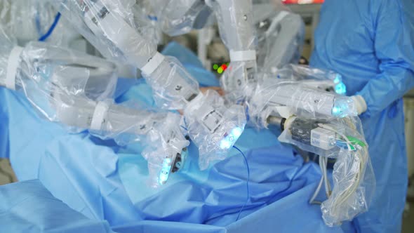 Futuristic robotic arms doing a surgery