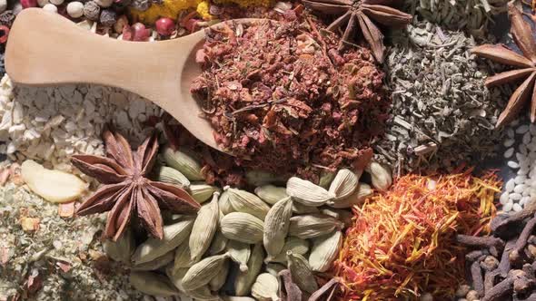 Spices and Herbs Rotate on a Stone Background