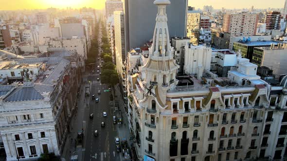 Aerial lowering on El Molino coffeehouse restored building and tower with windmills at sunset in bus