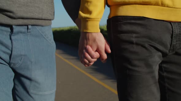 Close-up of Happy Gay Couple Holding Hands Outdoor