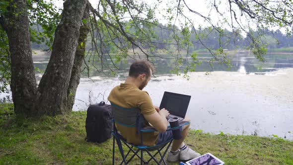 Happy and joyful man working with laptop.