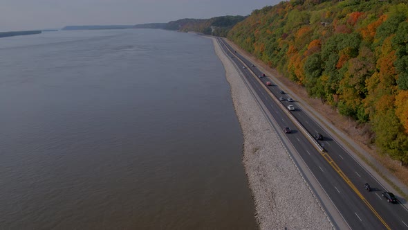 Drone pushes forward alongside the Great River Road and bluffs in the fall