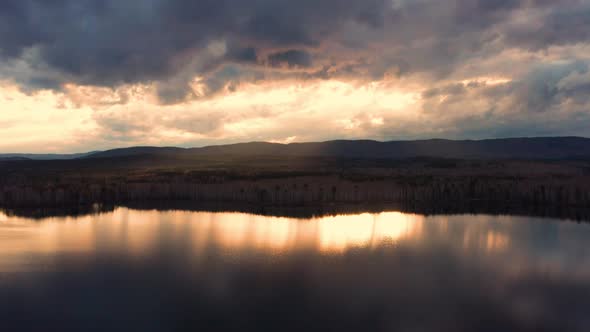 Aerial View of the Natural Landscape Forest on the Lake Shore at Sunset
