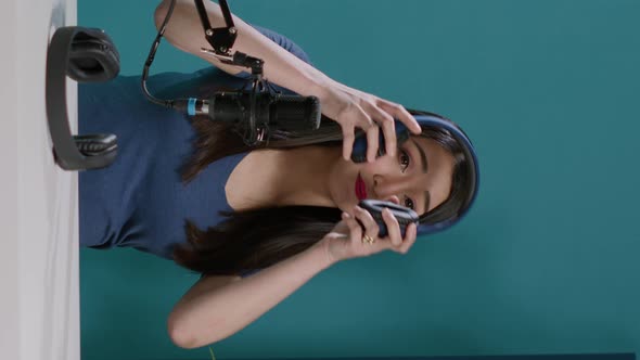 Vertical Video POV of Asian Woman Doing Recommendation of Modern Headphones