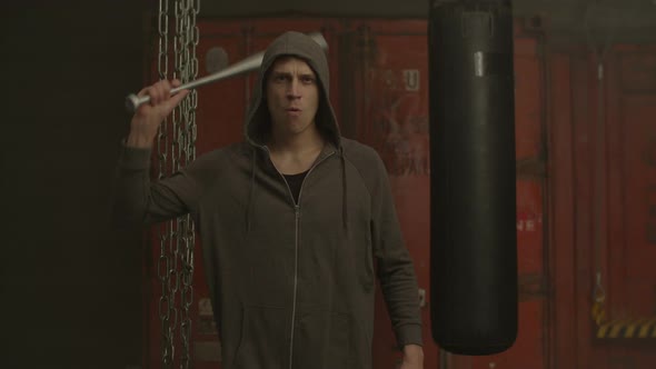 Hooligan in Hoodie Threatening with Baseball Bat