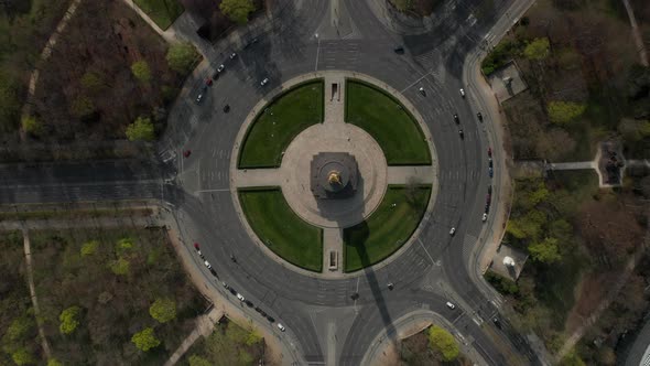 AERIAL: Overhead Birds Eye Drone View Rising Over Berlin Victory Column Roundabout with Little Car