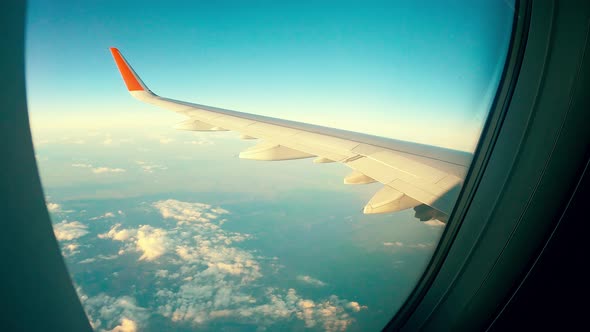 Aircraft's Window with the Ground and the Wing Seen From It