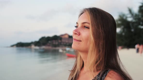 Beautiful Joyful Woman Enjoying Peaceful Seaside at Sunset Time