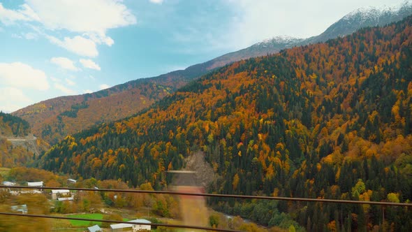 camera shoots from first person, car is driving along a narrow mountain road.