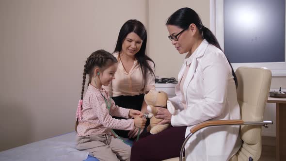 Happy Child Playing Doctor with Stethoscope