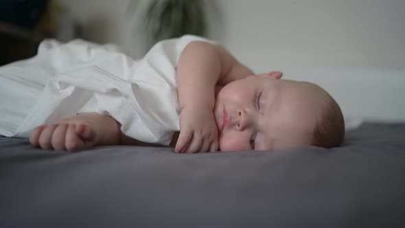 Cute Emotional Newborn Yawning Funny Little Baby Boy Sleeping in Crib