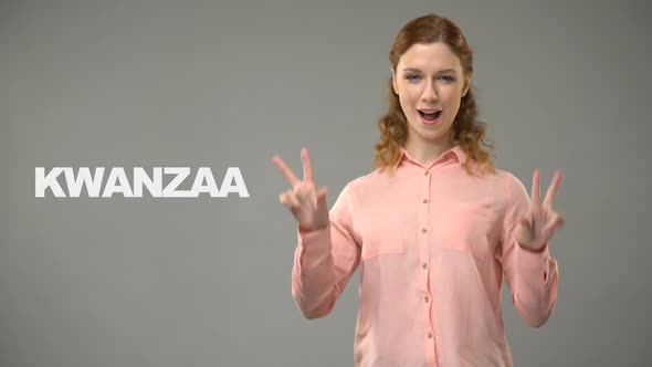 Deaf Lady Saying Kwanzaa in Sign Language, Text on Background, Communication