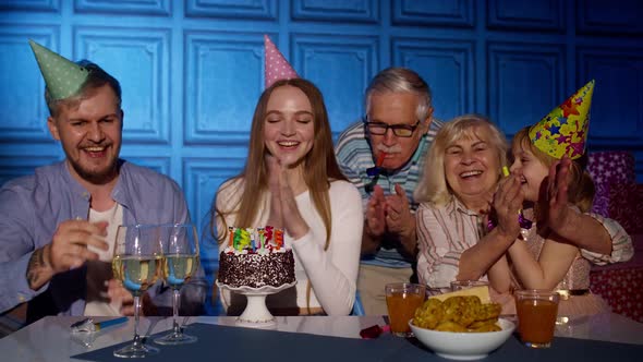 Happy Birthday Woman Blowing Candles on Cake Making Wish Having Fun Celebrating Party with Family