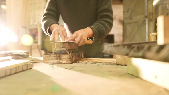 Bladesmith grinding a knife on grindstone