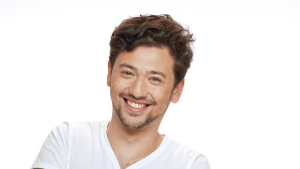 Young Handsome Man Smiling Beckoning Looking at Camera Over White Background