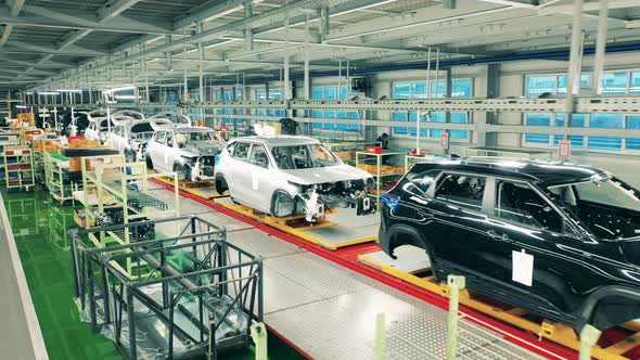 Automotive Factory Conveyor. Black and White Car Bodies on Assembly Line at Car Factory