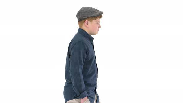 Stylish Teenage Boy with Hands in Pockets Walking on White Background