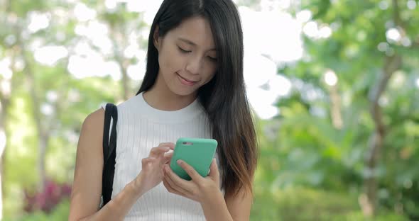 Woman use of mobile phone at outdoor 