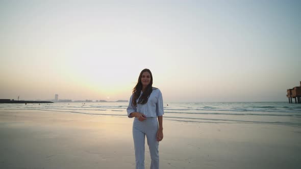 Portrait of Attractive Woman on the Beach with Dubai Cityscape in the Background