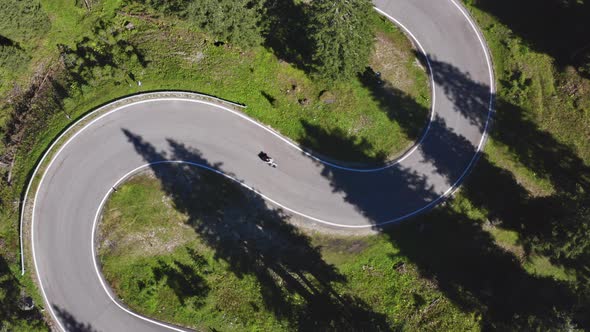 Aerial Shot of Winding Road with Bicycles Forest Trees on Both Sides