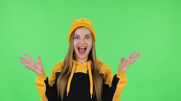 Portrait of Modern Girl in Yellow Hat with Shocked Surprised Wow Face Expression Is Rejoicing. Green