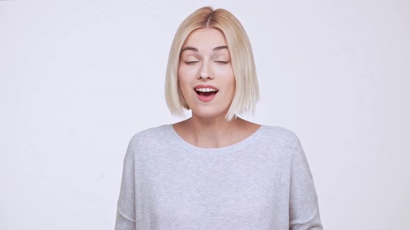 Young Beautiful Blonde Girl Surprised Excited Showing Thumb Up Over White Background Slow Motion