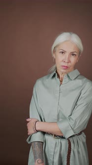 Vertical Portrait of Mature Woman with Arm Tattoo