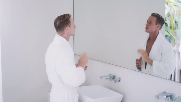 Handsome Guy Adjusts Hairstyle and Washes Hands in Bathroom