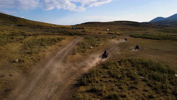 Aerial View From Behind ATVs by Lake and Mountain