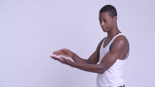 Young Happy African Man Snapping Fingers and Showing Something