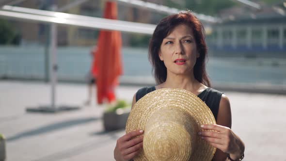 Medium Shot Portrait Slim Caucasian Beautiful Woman Standing on Hot Sunny Day Outdoors Using Straw