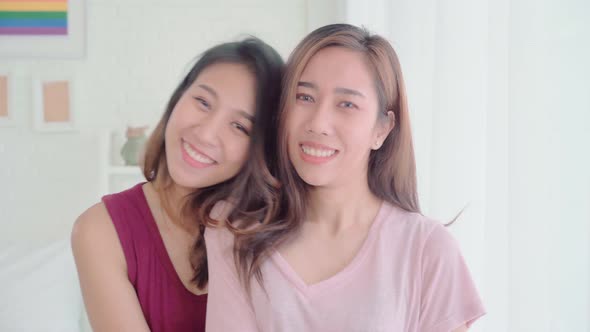 Young Asian women lesbian happy couple smiling and looking to camera while relax in her bedroom