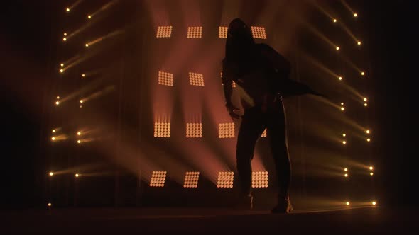 Breakdance Concept. Trendy Young Man Dancing Single in Club, Neon Light, Lots of Smoke. Fashion