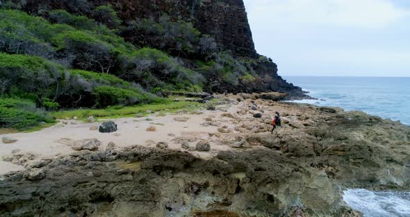 Couple walking on the rocky sea coast 