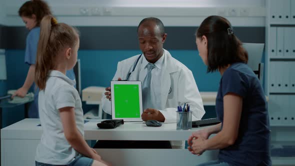 African American Medic Holding Green Screen on Digital Tablet