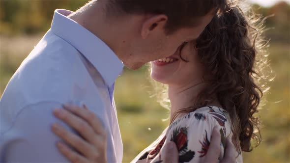Happy Teenage Couple First Kiss Girl Kissing. Loving Couple Embracing.